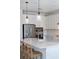 Bright kitchen features stainless steel appliances, white cabinetry, and a large center island with bar seating at 17737 Savory Mist Cir, Bradenton, FL 34211