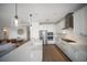 Bright kitchen with an island and stainless steel appliances overlooking the living room at 17737 Savory Mist Cir, Bradenton, FL 34211