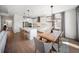 Open concept kitchen with stainless appliances, white cabinets, island, and view of dining area at 17737 Savory Mist Cir, Bradenton, FL 34211