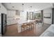 Bright kitchen with stainless appliances, white cabinets, large island, and view of dining area at 17737 Savory Mist Cir, Bradenton, FL 34211
