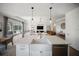 Bright kitchen with an island and stainless steel dishwasher overlooking the dining area and living room at 17737 Savory Mist Cir, Bradenton, FL 34211