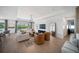 Bright living room featuring a large window, white sofa, unique seating, and modern decor at 17737 Savory Mist Cir, Bradenton, FL 34211