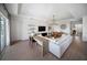 Open-concept living room with a desk, large white sofa, and view to the kitchen at 17737 Savory Mist Cir, Bradenton, FL 34211