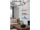 Living room showing floating shelves, stylish furniture, and neutral color scheme at 17737 Savory Mist Cir, Bradenton, FL 34211