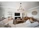 Inviting living room with a modern chandelier, comfortable seating, and stylish decor at 17737 Savory Mist Cir, Bradenton, FL 34211