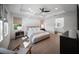 Bright main bedroom with tray ceilings, hardwood floors, ensuite bathroom, and natural light at 17737 Savory Mist Cir, Bradenton, FL 34211
