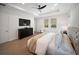 Bedroom features tray ceilings, hardwood floors, a ceiling fan, and ensuite bathroom at 17737 Savory Mist Cir, Bradenton, FL 34211