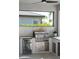 An outdoor kitchen featuring stainless steel appliances, grill, beverage cooler, and storage at 17737 Savory Mist Cir, Bradenton, FL 34211