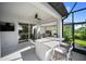 Covered patio boasts a built-in outdoor kitchen, bar seating, and a ceiling fan at 17737 Savory Mist Cir, Bradenton, FL 34211