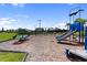 Well-equipped community playground with various play structures, swings, and a soft ground covering at 17737 Savory Mist Cir, Bradenton, FL 34211