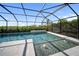 Beautiful screened-in pool features a spa area, lush landscaping for privacy, and clear blue skies at 17737 Savory Mist Cir, Bradenton, FL 34211