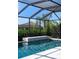 This screened-in pool features an elevated waterfall feature at 17737 Savory Mist Cir, Bradenton, FL 34211