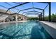 Resort-style screened-in pool with a tanning ledge and waterfall feature, perfect for relaxation at 17737 Savory Mist Cir, Bradenton, FL 34211
