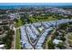 Aerial view showcasing a residential neighborhood with well-maintained townhomes, green spaces, and cityscape views at 2217 Muesel St, Sarasota, FL 34237