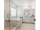 Bright bathroom with a glass shower, soaking tub, and a double sink vanity at 2217 Muesel St, Sarasota, FL 34237