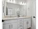 Bright bathroom featuring a double sink vanity, light countertops, and a large mirror at 2217 Muesel St, Sarasota, FL 34237