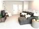 Upstairs bonus room with soft gray sofa, side table, and bright, natural light at 2217 Muesel St, Sarasota, FL 34237