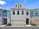 Charming two-story home with a clean white facade, complemented by a blue door and integrated garage at 2217 Muesel St, Sarasota, FL 34237