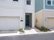 Close-up of the house's front entrance, highlighting the walkway, landscaping, and blue-colored front door at 2217 Muesel St, Sarasota, FL 34237