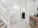 Bright hallway features neutral carpet, white railing staircase and a laundry room ready for chores at 2217 Muesel St, Sarasota, FL 34237