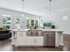 Kitchen island with stainless steel sink and dishwasher; open layout with dining area and living room views at 2217 Muesel St, Sarasota, FL 34237