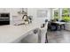 Modern kitchen with white cabinetry, a large island, and stainless steel appliances that are well lit at 2217 Muesel St, Sarasota, FL 34237