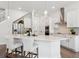 Modern kitchen featuring white cabinets, stainless steel appliances, and a spacious island with seating at 2217 Muesel St, Sarasota, FL 34237