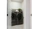 Modern laundry room features tile floor, new washer and dryer and added shelf space at 2217 Muesel St, Sarasota, FL 34237