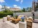 Cozy outdoor patio featuring modern furniture, a neutral rug, and lush landscaping for a relaxing retreat at 2217 Muesel St, Sarasota, FL 34237
