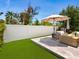 Outdoor patio area features stylish furniture, umbrella, and artificial turf with a privacy fence at 2217 Muesel St, Sarasota, FL 34237