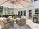 Comfortable outdoor patio area boasts an umbrella, stylish seating, and a grill for entertaining at 2217 Muesel St, Sarasota, FL 34237