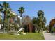 Contemporary metal sculpture showcased in a lush park setting with palm trees and a walking path at 2217 Muesel St, Sarasota, FL 34237