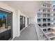 Wide balcony with lots of space and sliding glass doors leading to the home's interior at 2295 Gulf Of Mexico Dr # 64S, Longboat Key, FL 34228