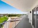 Wide balcony with a gorgeous view of the community including parking, green areas, and the city on the horizon at 2295 Gulf Of Mexico Dr # 64S, Longboat Key, FL 34228