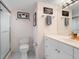 Clean bathroom with a shower, toilet, sink, and a white color palette at 2295 Gulf Of Mexico Dr # 64S, Longboat Key, FL 34228