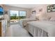 Bedroom with two beds, beach view from balcony, and a light color pallette at 2295 Gulf Of Mexico Dr # 64S, Longboat Key, FL 34228