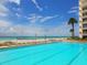 Community pool with ocean view and lots of seating near the beach at 2295 Gulf Of Mexico Dr # 64S, Longboat Key, FL 34228