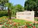 Stone Islander Club community sign surrounded by lush tropical landscaping and colorful flowers at 2295 Gulf Of Mexico Dr # 64S, Longboat Key, FL 34228