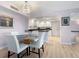Bright dining area adjacent to the kitchen, featuring a table set for four and contemporary lighting at 2295 Gulf Of Mexico Dr # 64S, Longboat Key, FL 34228