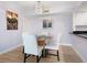 Chic dining area with a round table, stylish chairs, and a modern chandelier at 2295 Gulf Of Mexico Dr # 64S, Longboat Key, FL 34228