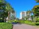 Lush greenery frames the buildings against a clear blue sky at 2295 Gulf Of Mexico Dr # 64S, Longboat Key, FL 34228