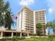 Elegant high-rise condominium boasting multiple balconies, lush landscaping, and a prime location at 2295 Gulf Of Mexico Dr # 64S, Longboat Key, FL 34228
