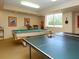 Well-lit game room with a pool table and ping pong table for entertainment at 2295 Gulf Of Mexico Dr # 64S, Longboat Key, FL 34228
