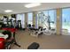 Well-equipped gym with treadmills, weights, and ocean views through large windows at 2295 Gulf Of Mexico Dr # 64S, Longboat Key, FL 34228