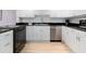 Bright kitchen features white cabinets, stainless steel appliances, and modern countertops at 2295 Gulf Of Mexico Dr # 64S, Longboat Key, FL 34228