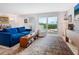 Bright living room featuring comfortable seating, a large rug, and sliding glass doors to the balcony at 2295 Gulf Of Mexico Dr # 64S, Longboat Key, FL 34228