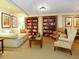 Cozy living room with bookshelves, comfortable seating, and warm lighting at 2295 Gulf Of Mexico Dr # 64S, Longboat Key, FL 34228