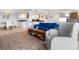 Open-concept living area with a comfortable sofa, accent chair, and seamless flow to the dining area at 2295 Gulf Of Mexico Dr # 64S, Longboat Key, FL 34228