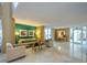 Beautiful lobby with neutral color palette, seating area, artwork, and direct access to the outside at 2295 Gulf Of Mexico Dr # 64S, Longboat Key, FL 34228