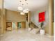 Spacious lobby featuring high ceilings, elegant lighting, marble floors, and a grand staircase at 2295 Gulf Of Mexico Dr # 64S, Longboat Key, FL 34228
